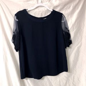 Navy blue blouse with floral lace accent sleeves